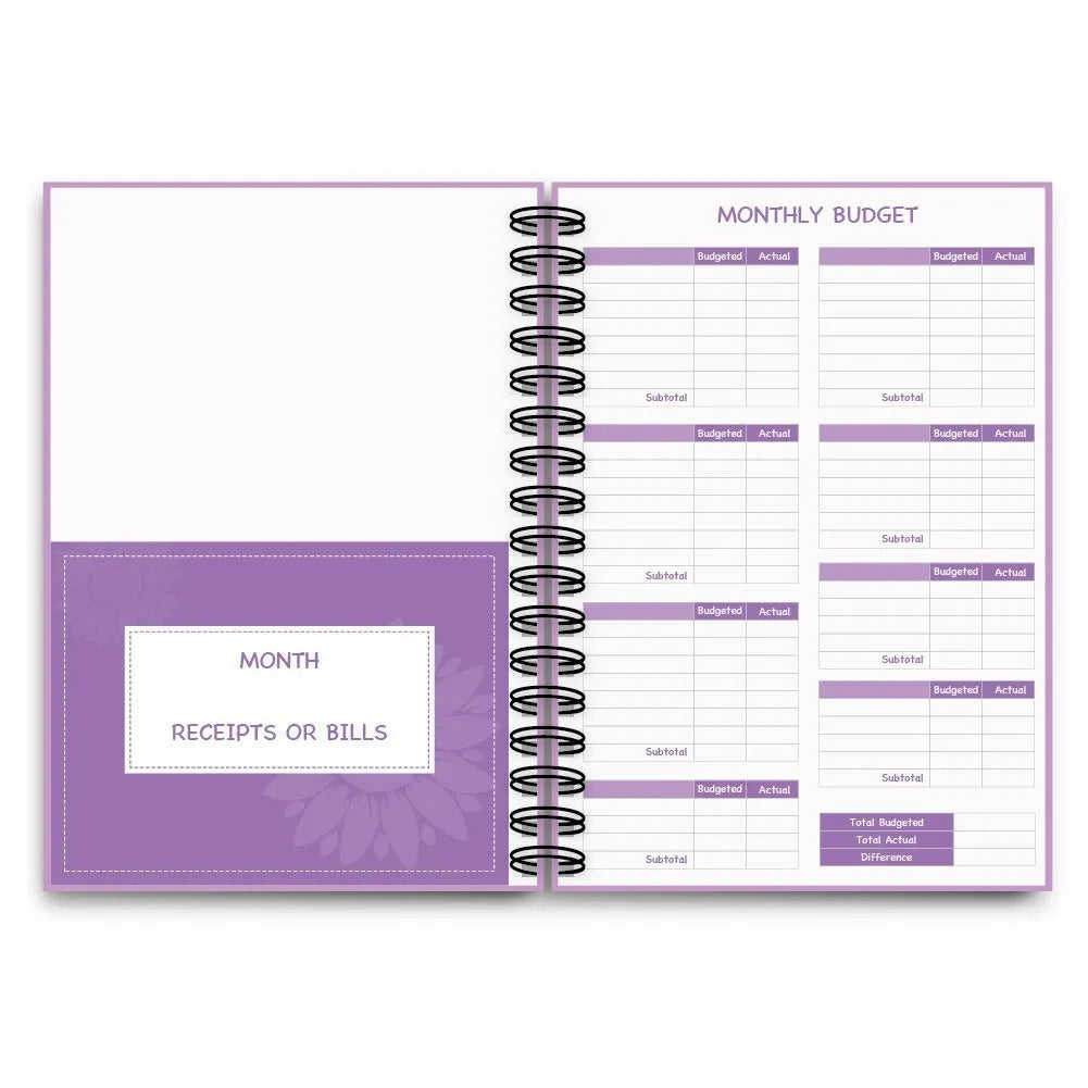 Purple coil-bound A5 financial planning notebook with pen, stickers, and paper clips for monthly budgeting