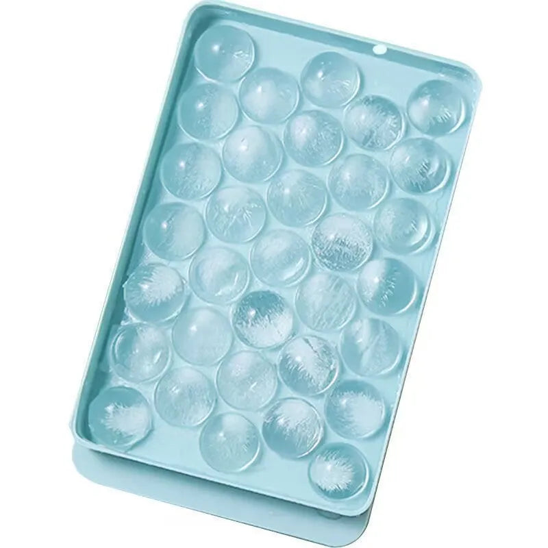 Blue silicone ice cube tray with 33 round cavities and clear snap-on lid