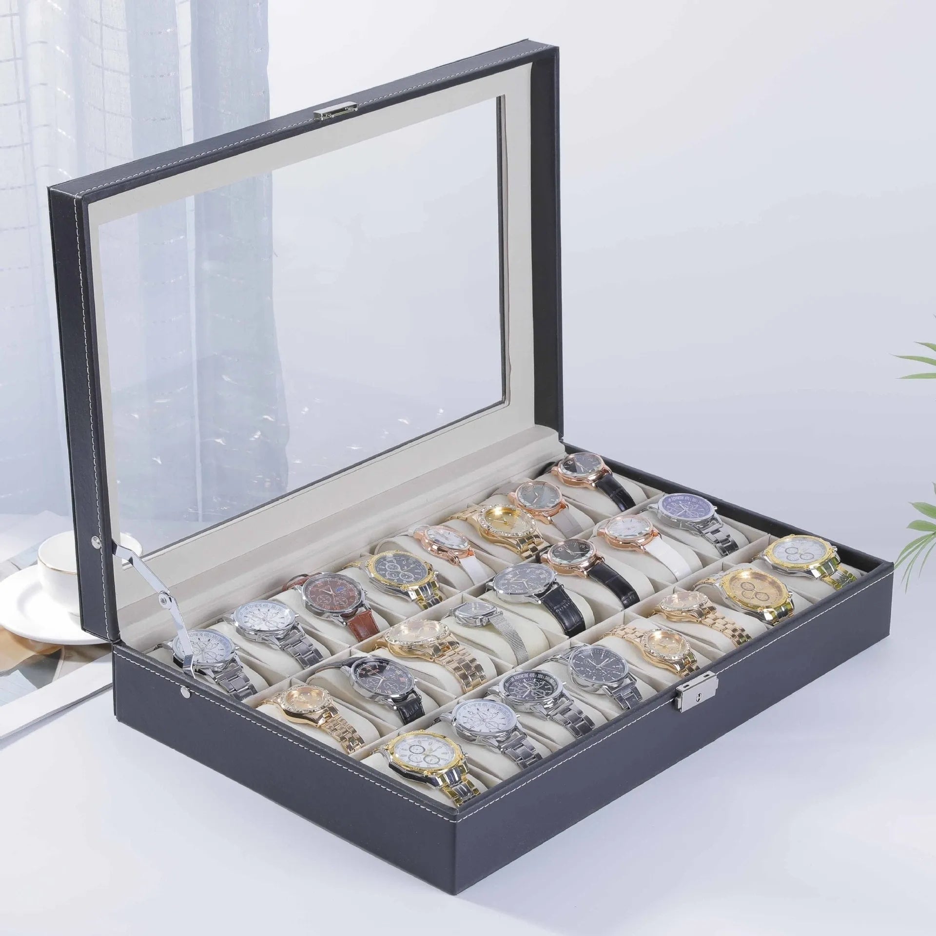 Leather watch storage box with clear dustproof lid showing multiple watch compartments