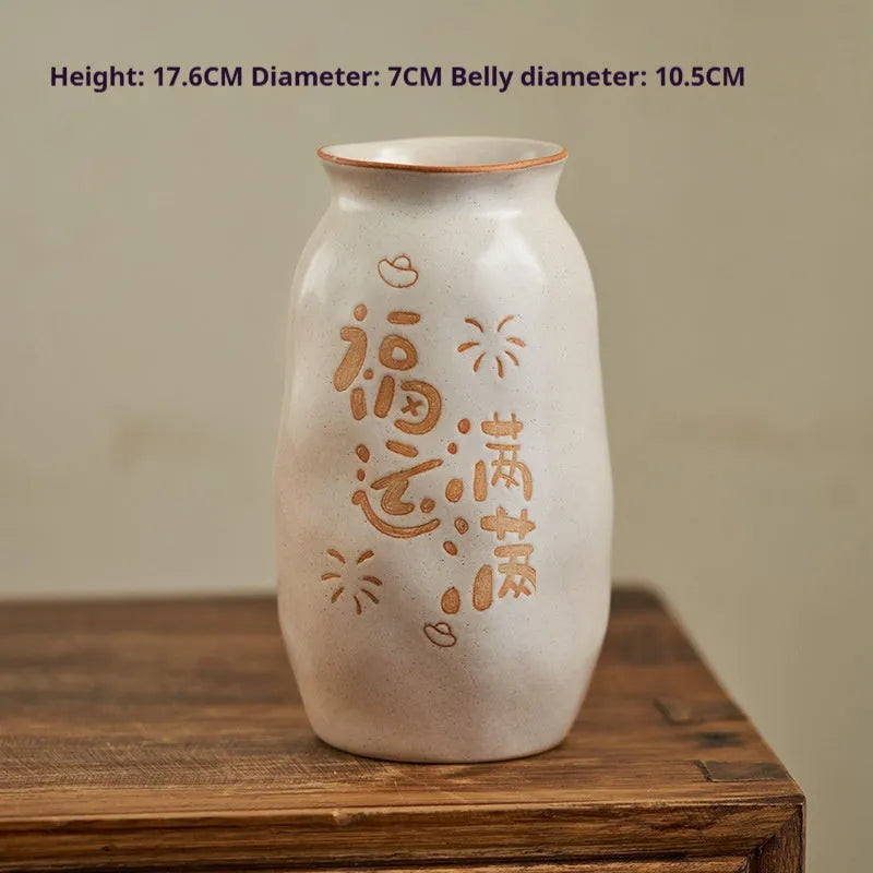 Chinese hand-painted ceramic vase with carved design on wooden desktop