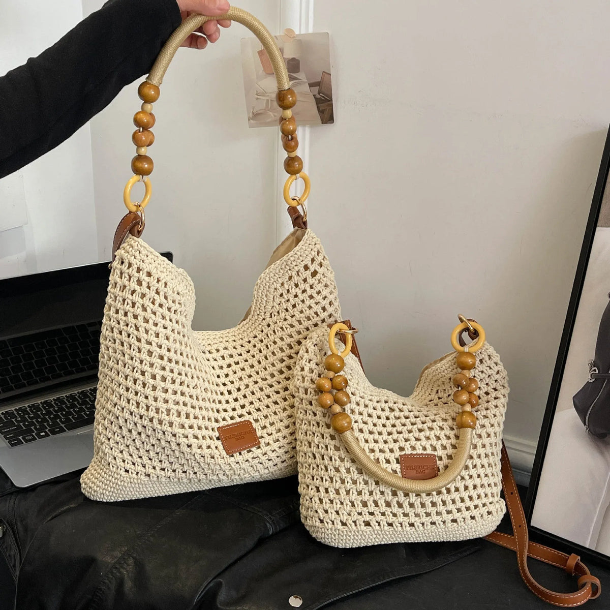 Knitted tote beach bag in bucket shape with contrast stitching and crossbody strap