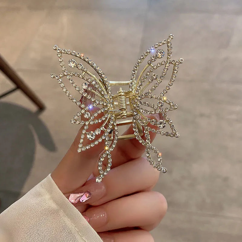 Butterfly-shaped alloy hair clip for women with electroplated finish, shown in rhinestone and pearl styles.
