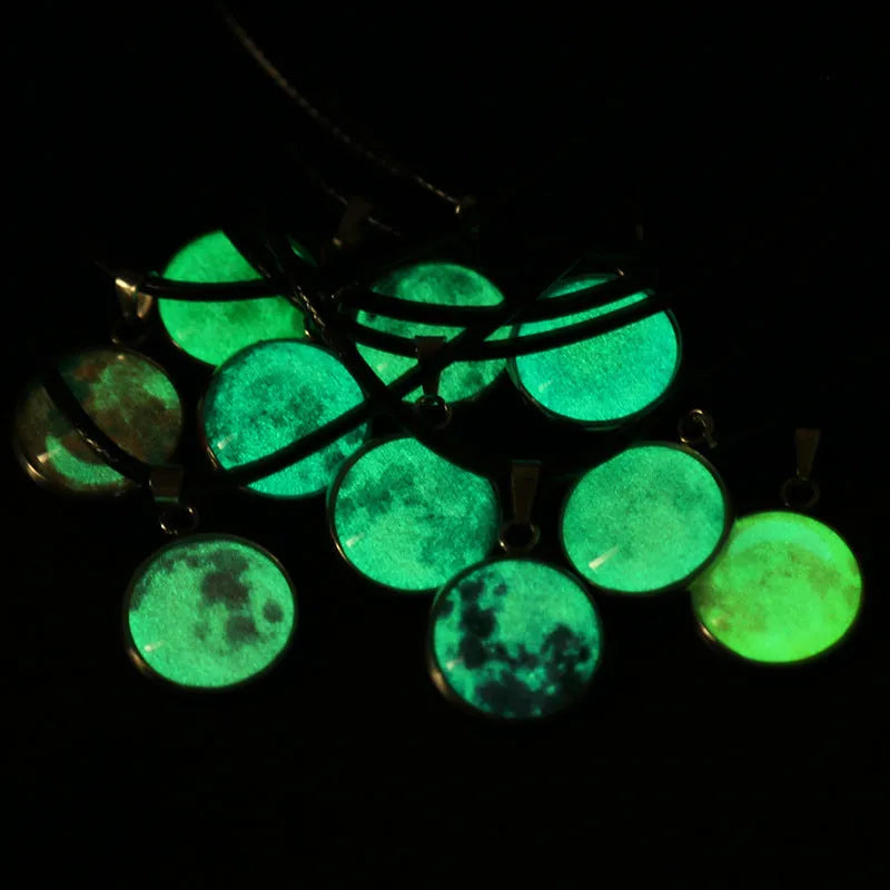Close-up of a luminous alloy necklace with a blue organic glass constellation pendant on a model.