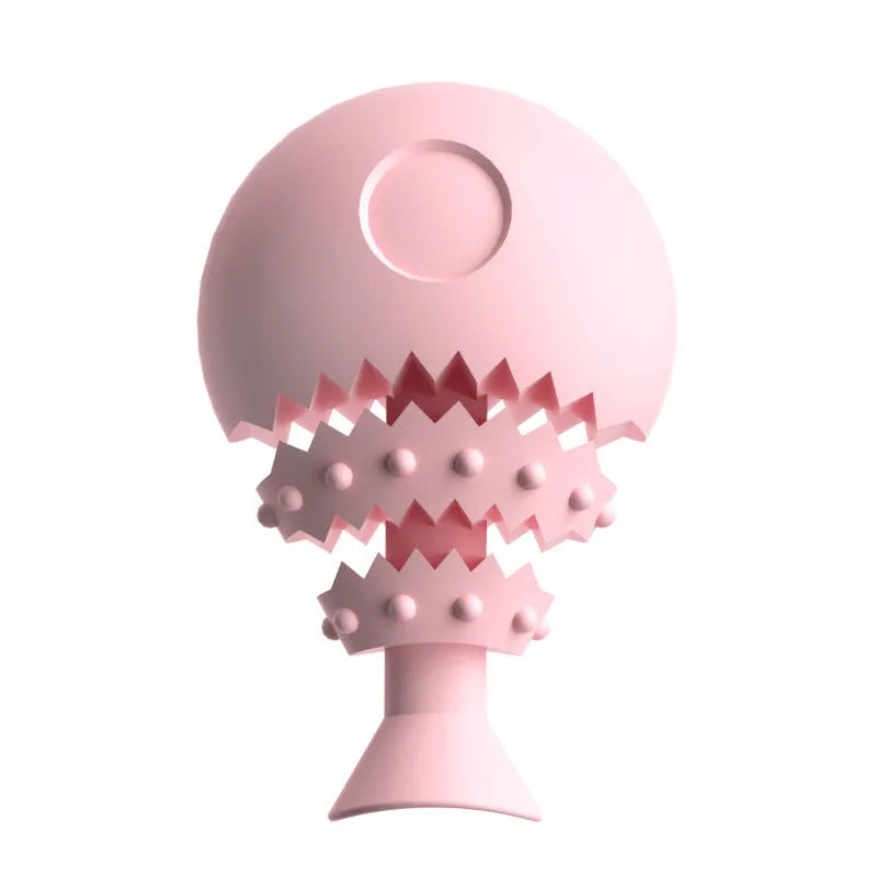 Blue, green, and pink rubber fish bone shaped dog chew toy with hollow centre for treats.
