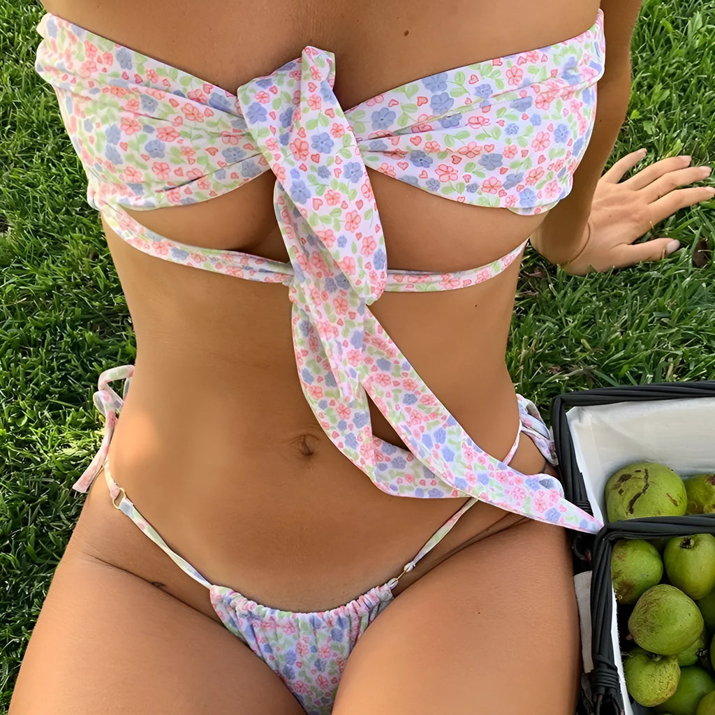 Women's lace-up split swimsuit with wireless cup and chest pad in a small floral print pattern.