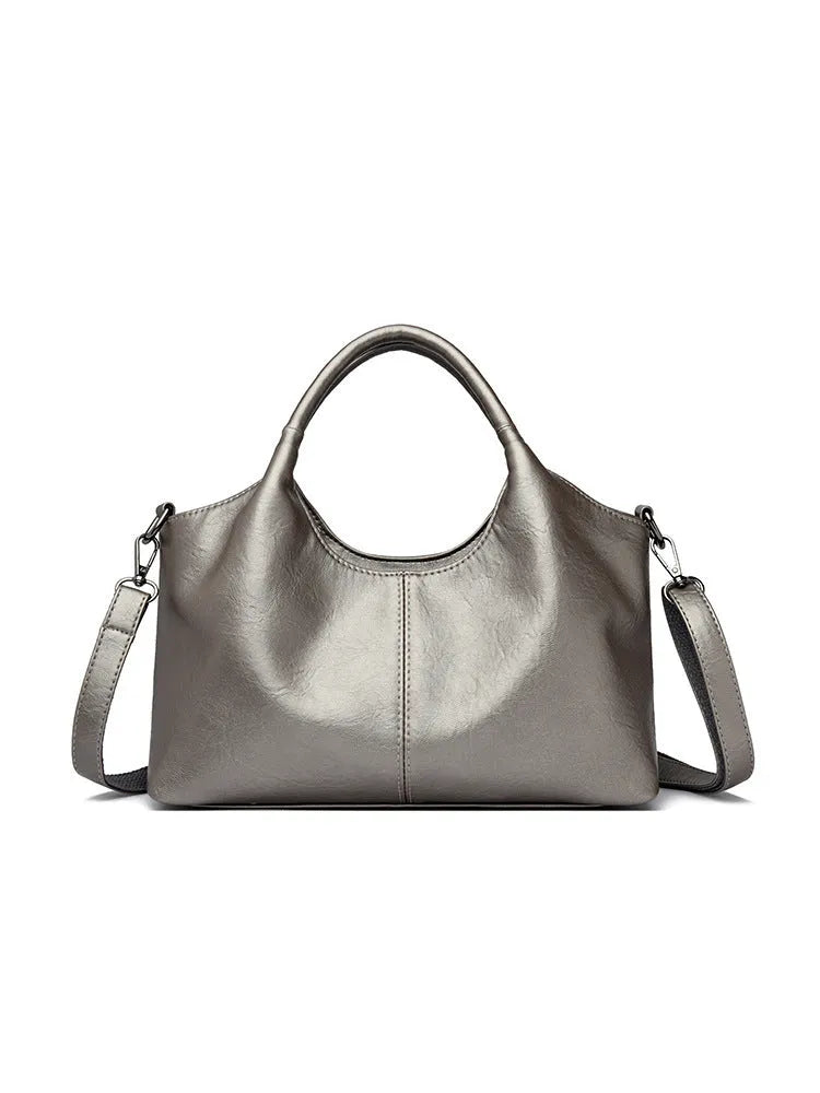 Genuine leather women's cross-body bag in black with adjustable shoulder strap showing interior polyester lining