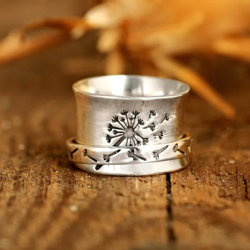 Silver rotatable flower fashion ring showing floral design and adjustable element