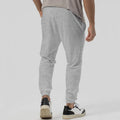 Men's grey cotton blend straight-leg track sweatpants with a mid waist and loose tapered fit on a hanger.