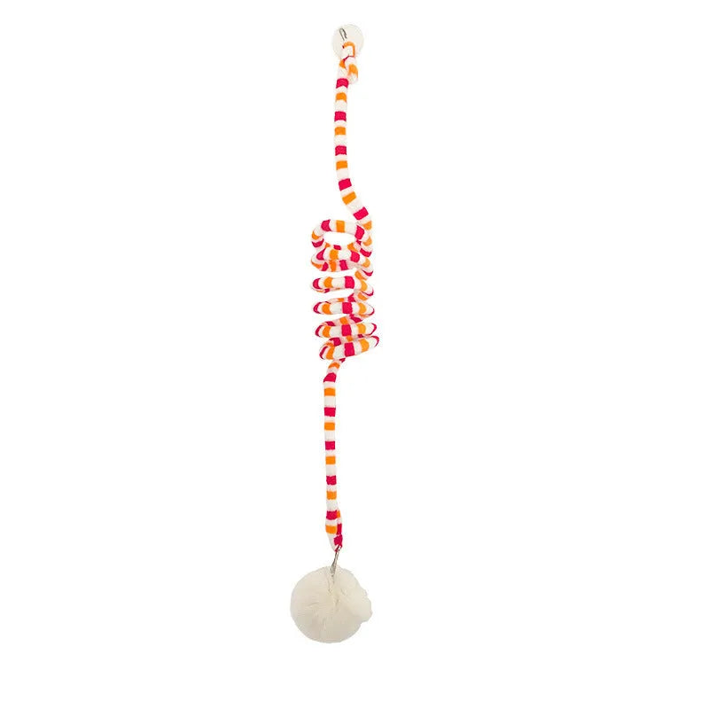 Colourful suction cup cat toy with spring wand and inflatable ball, hanging on a glass door