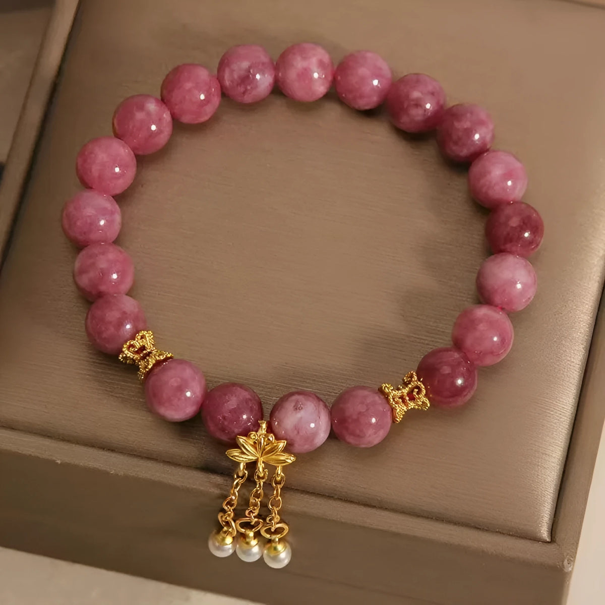 Natural stone bracelet with lotus tassel design, pearl pendant, and electroplated pink finish
