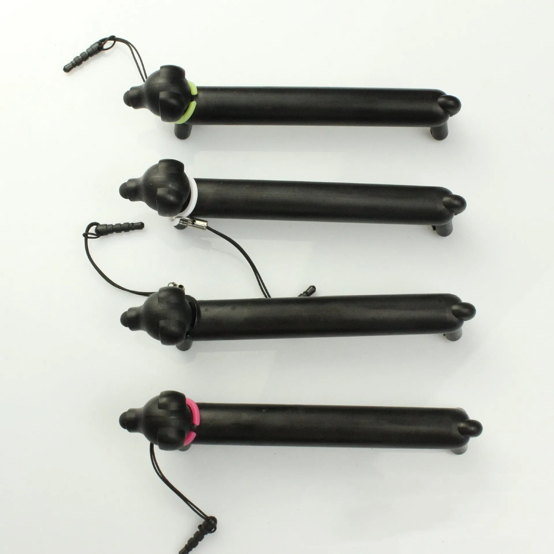 Black dog-shaped touch screen stylus showing split design for dual-length use and phone stand functionality