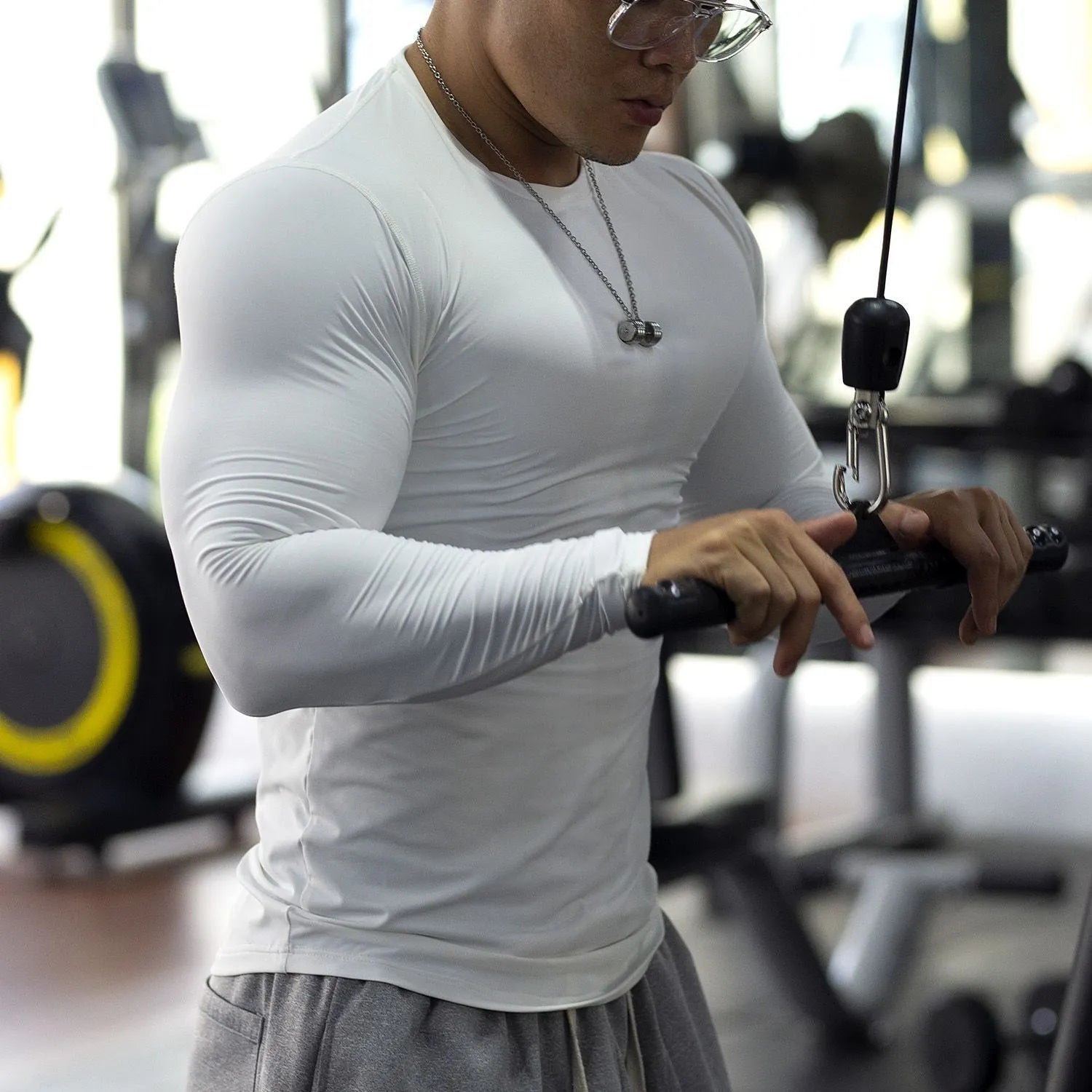 Men's black slim-fit long-sleeve fitness tights made from quick-dry nylon blend fabric.