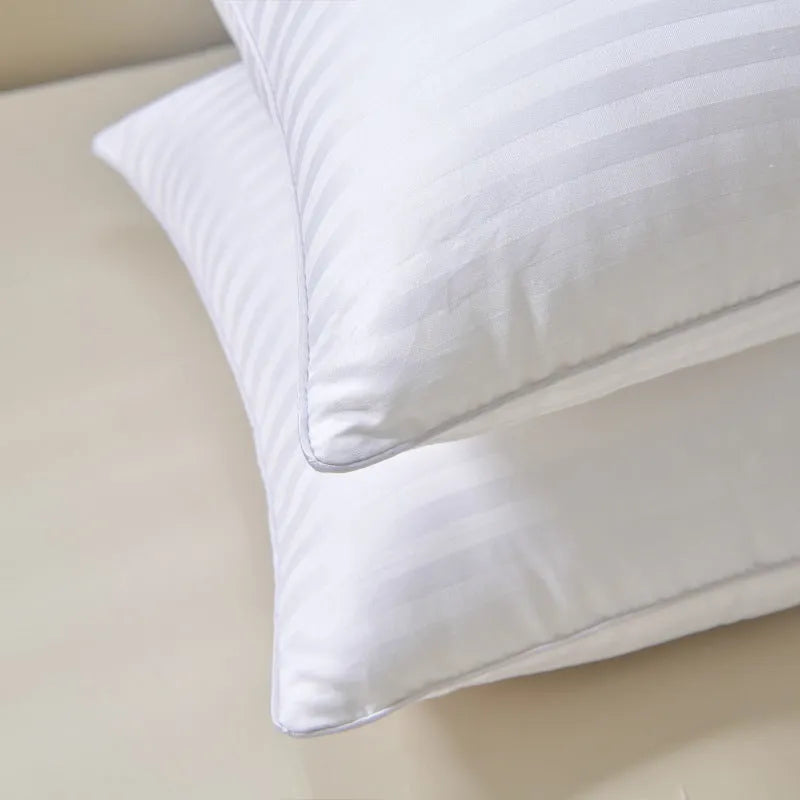 White cotton satin stripe feather and cotton pillow showing three size options