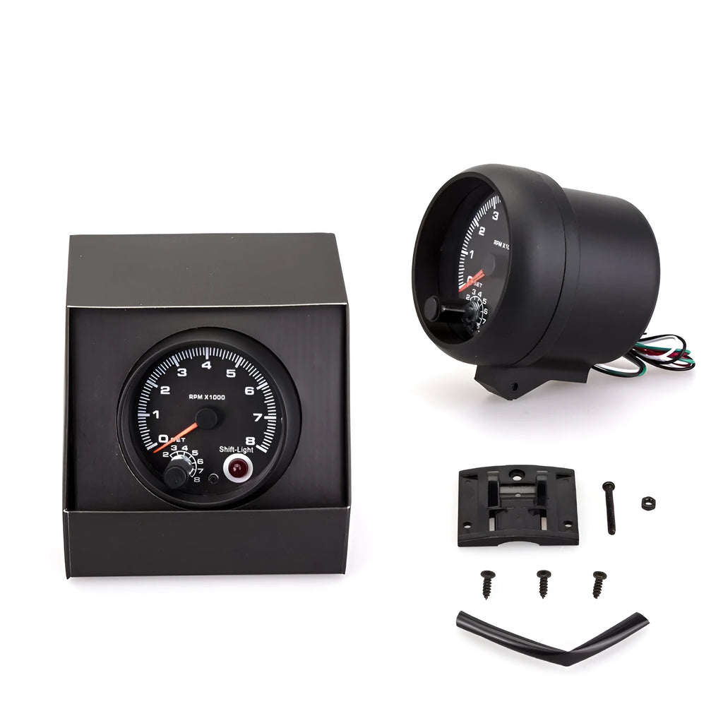 Black automotive tachometer with blue-lit dial showing RPM scale up to 8000
