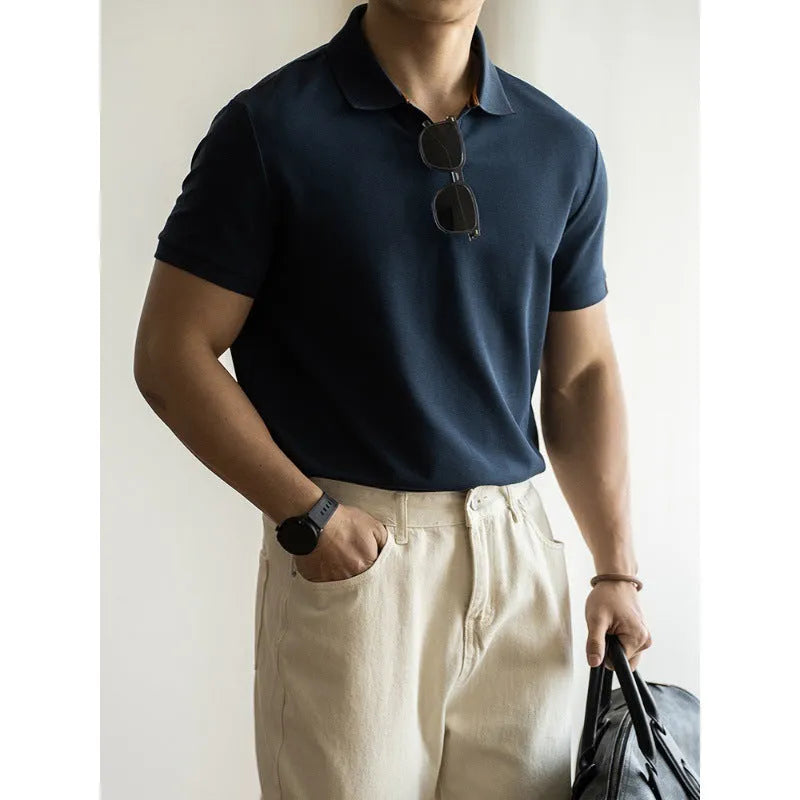 Man's short-sleeve blue polo shirt on a hanger, showing the classic collar and button placket.