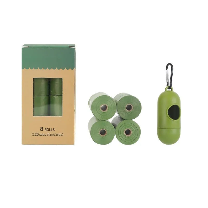 Roll of green EPI degradable pet garbage bags next to a boxed set with a dispenser.