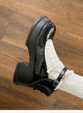 Women's beige and black Mary Jane shoes with a chunky heel and rounded toe.